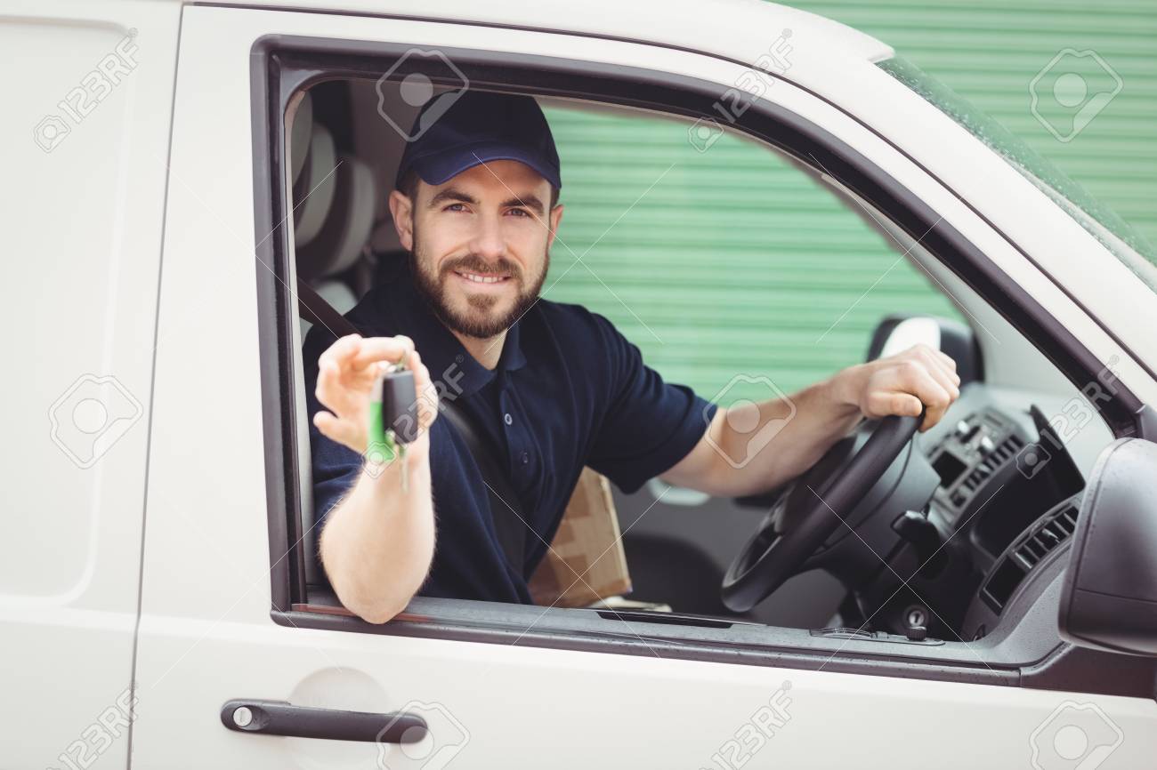 Delivery man sitting in his van while holding keys